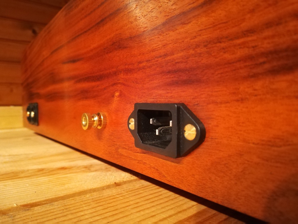 Copper shielding and grounding screw inside the plinth